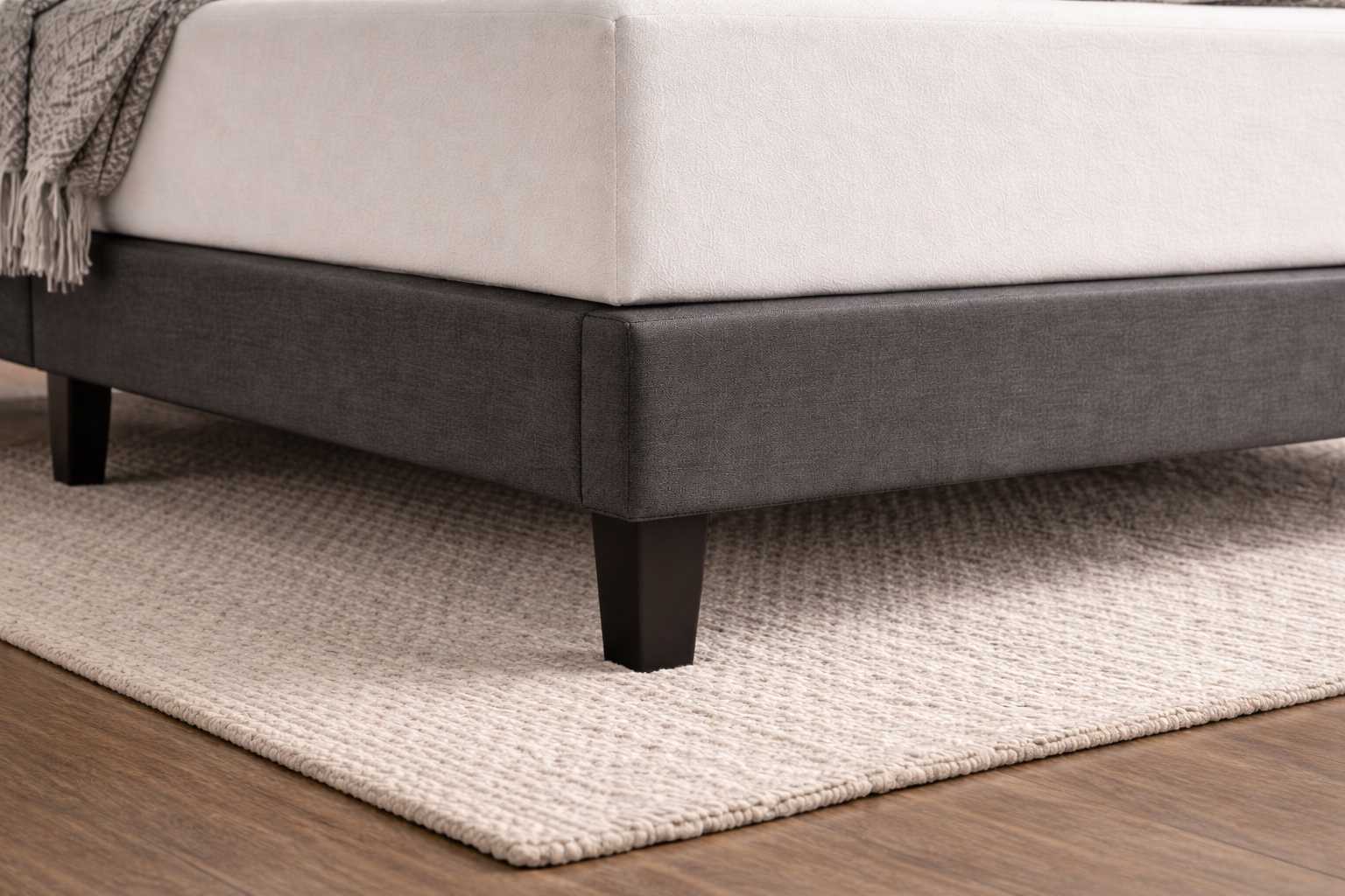 Fabric upholstered bed base and corner detailing of Becher bed set