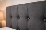 Button tufted fabric headboard detail on Becher bed set