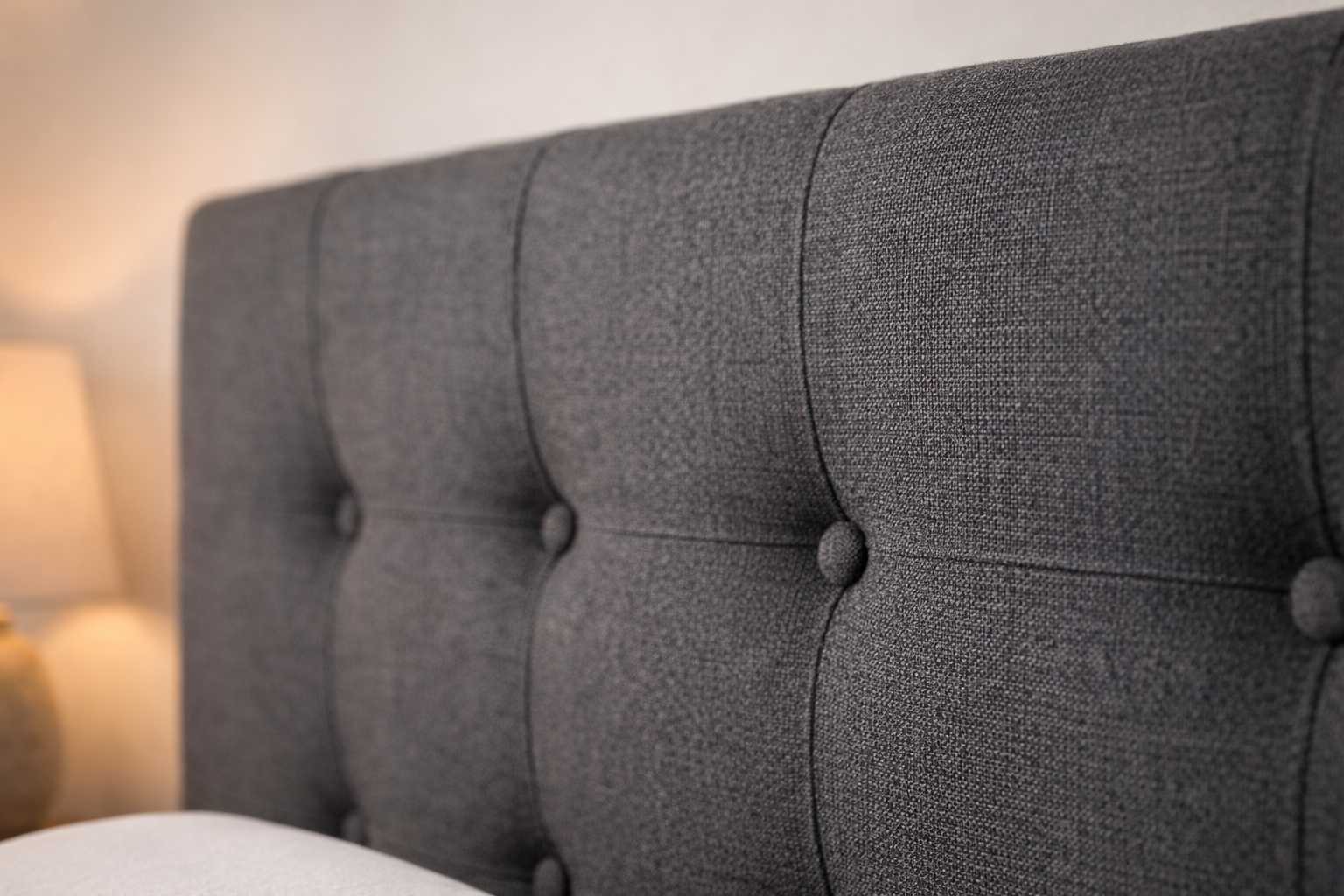 Button tufted fabric headboard detail on Becher bed set