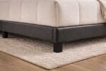 Leather upholstered bed base and corner detailing of Bengtson bed set