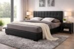 Black upholstered bed with square tufted headboard styled in a modern bedroom