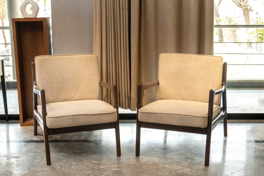 Luxorin sofa chair with beige upholstery and solid wooden frame