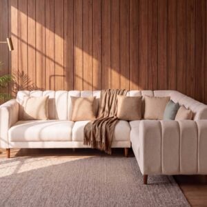 Serene beige L shape sofa with channel tufted back and wooden legs in modern living room setting