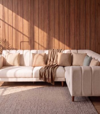 Serene beige L shape sofa with channel tufted back and wooden legs in modern living room setting