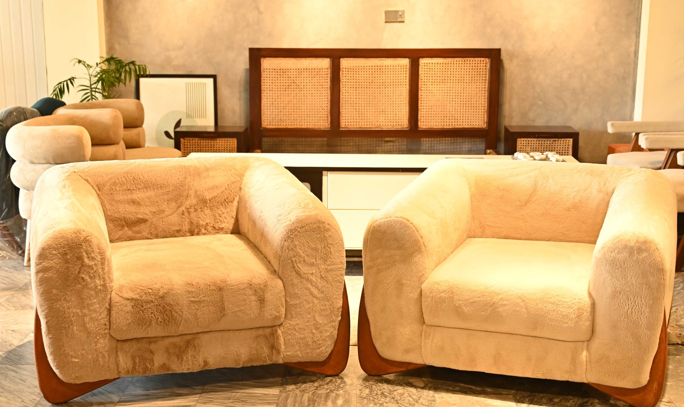 Modern single-seater Sherpa cloud sofa with plush cream faux fur and a bold rounded design by Renome