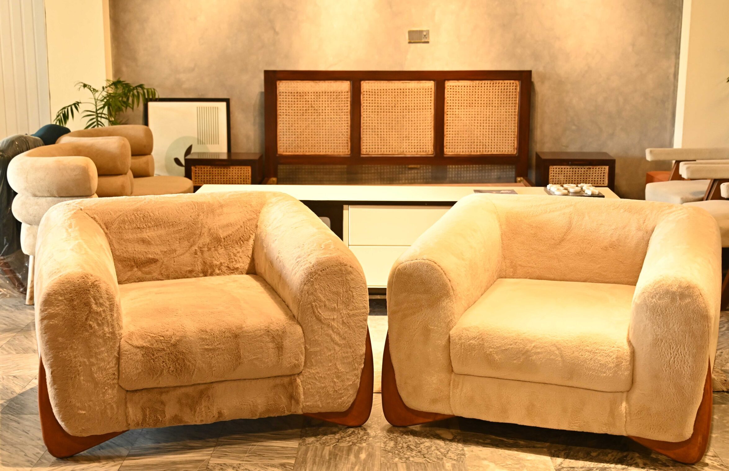 Modern single-seater Sherpa cloud sofa with plush cream faux fur and a bold rounded design by Renome