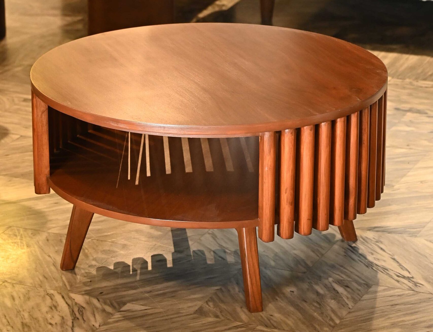 Round wooden coffee table with fluted slatted sides and tiered open storage shelf by Renome