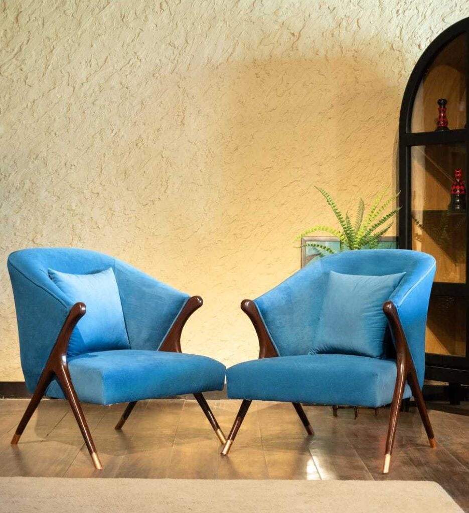 azure velvet accent chair with curved backrest and mid-century modern wooden frame by Renome