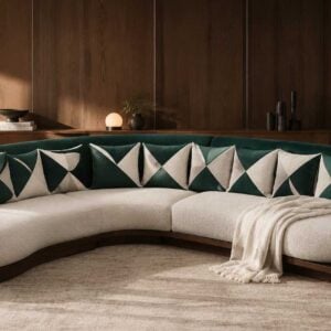 Curved emerald platform sofa with green velvet backrest, cream bouclé seating, and an extended dark wood base ledge by Renome
